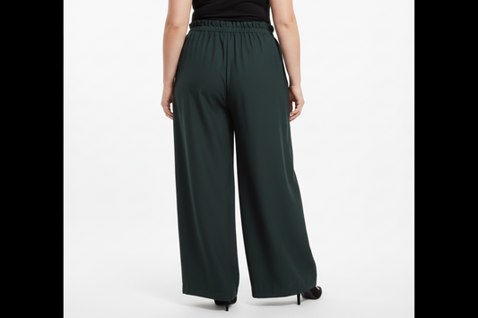 This photo shows a plus size model wearing the size adjustable green palazzo pants with rouching on the waistbelt from the back view.