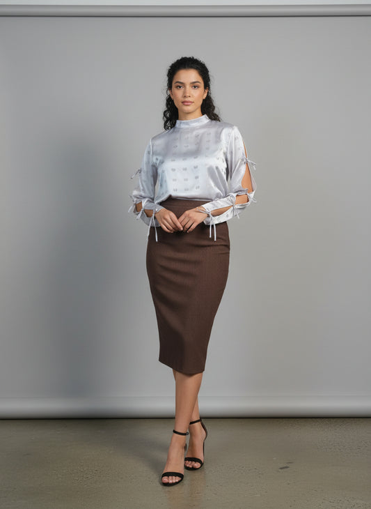 This photo shows a model size 8 wearing a brown satin size adjustable pencil skirt paired with the pink tie top