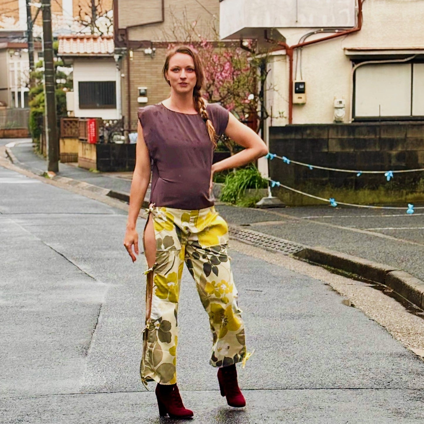 This photos shows a model wearing the size adjustable open thigh tie pants.