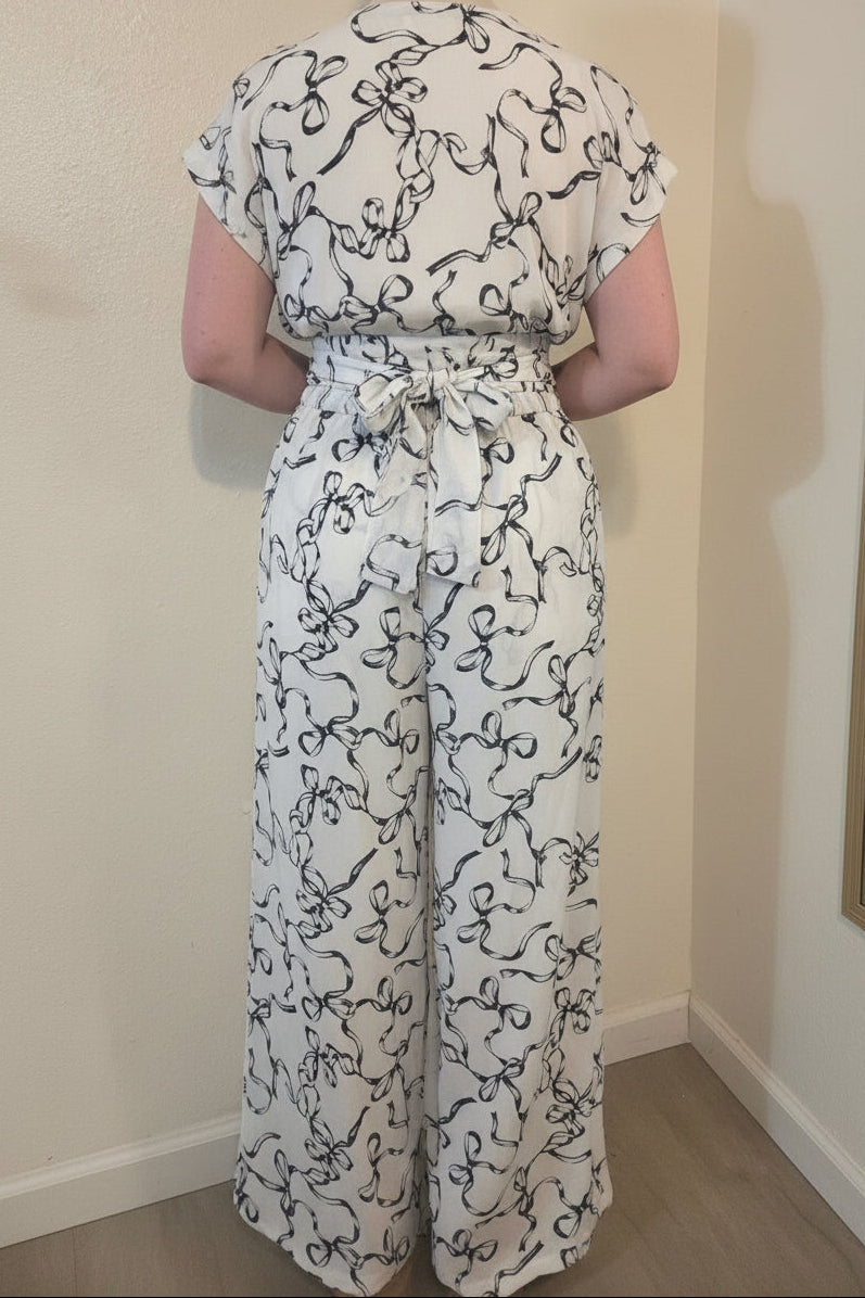 This photo shows a size 12 model wearing a black and white two piece outfit that is size adjustable