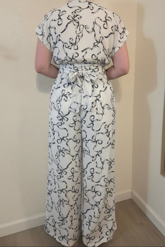 This photo shows a size 12 model wearing a black and white two piece outfit that is size adjustable