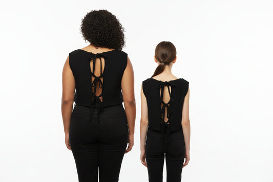 This photo shows two models of different sizes wearing the same shirt to show it's adjustable nature. Back view
