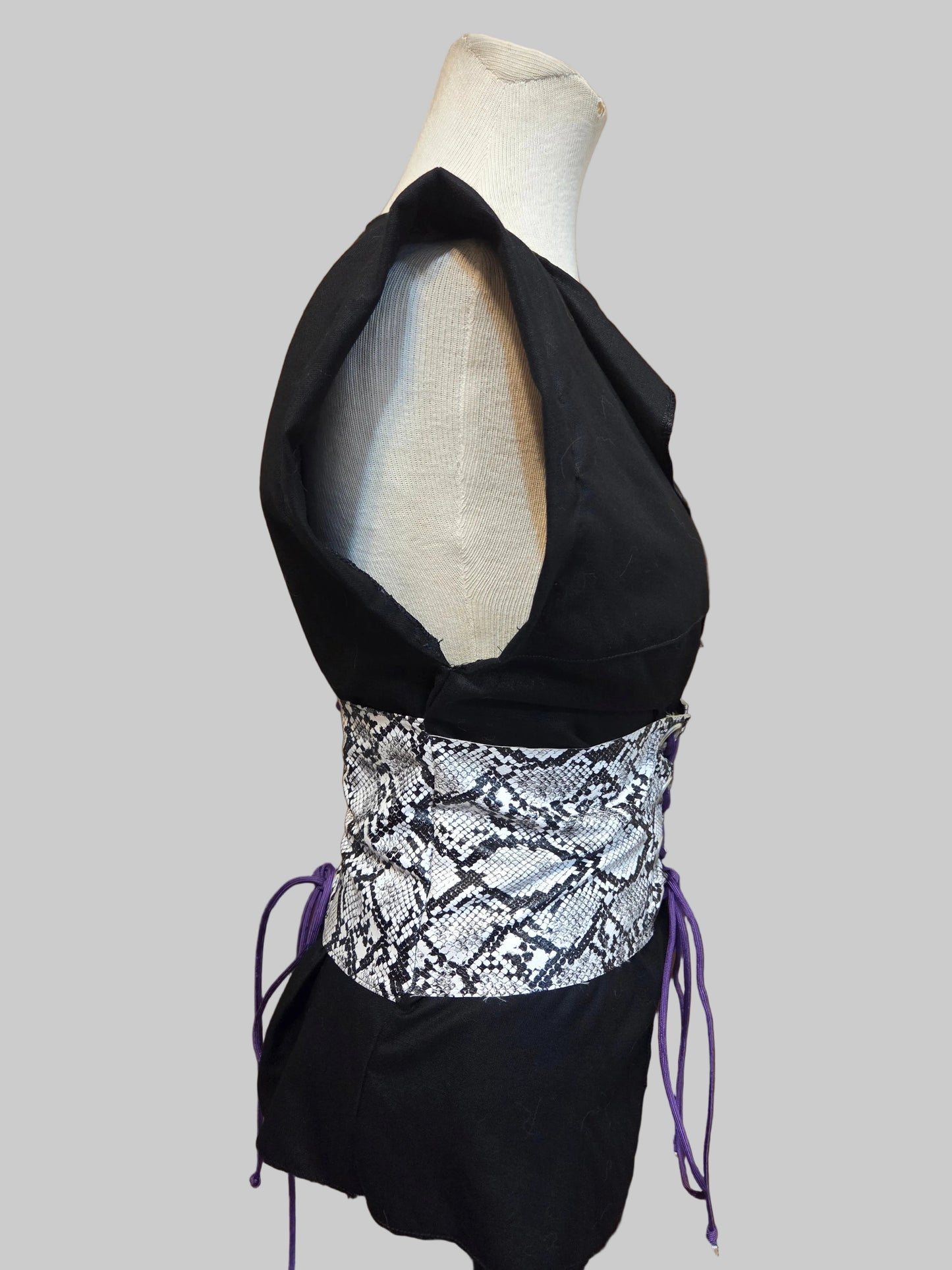 This photo shows a black linen shirt accented with a size adjustable faux snake skin corset over top