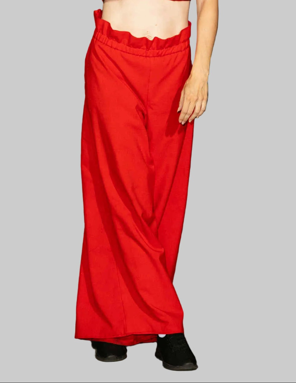This photo shows a model wearing the size adjustable palazzo pants in red. 
