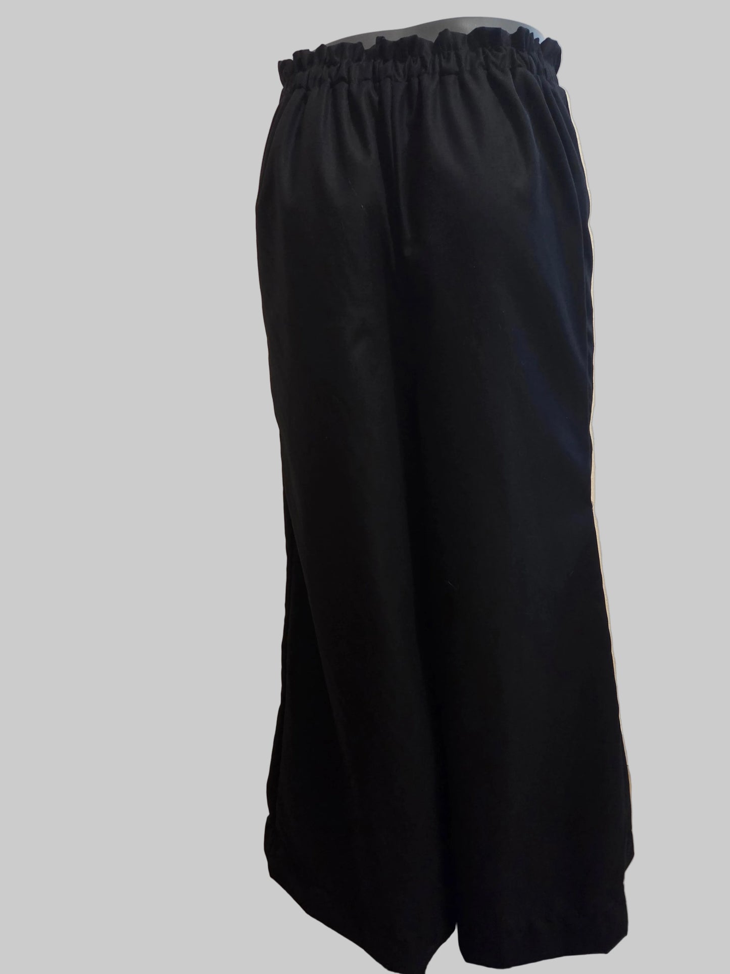 This photo shows a pair of linen black palazzo pants that are size adjustable from the back 