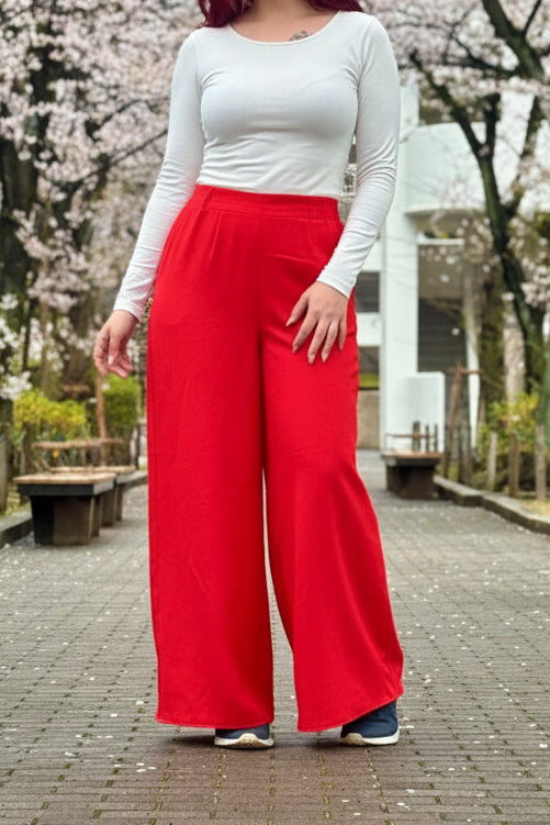 This photo shows a model wearing the size adjustable palazzo pants in red. 