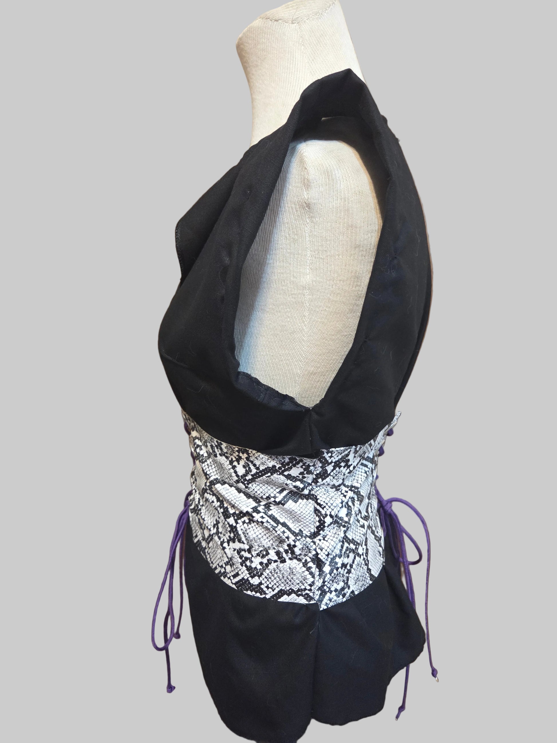 This photo shows a size adjustable black linen shirt with a faux snake skin corset on top. 