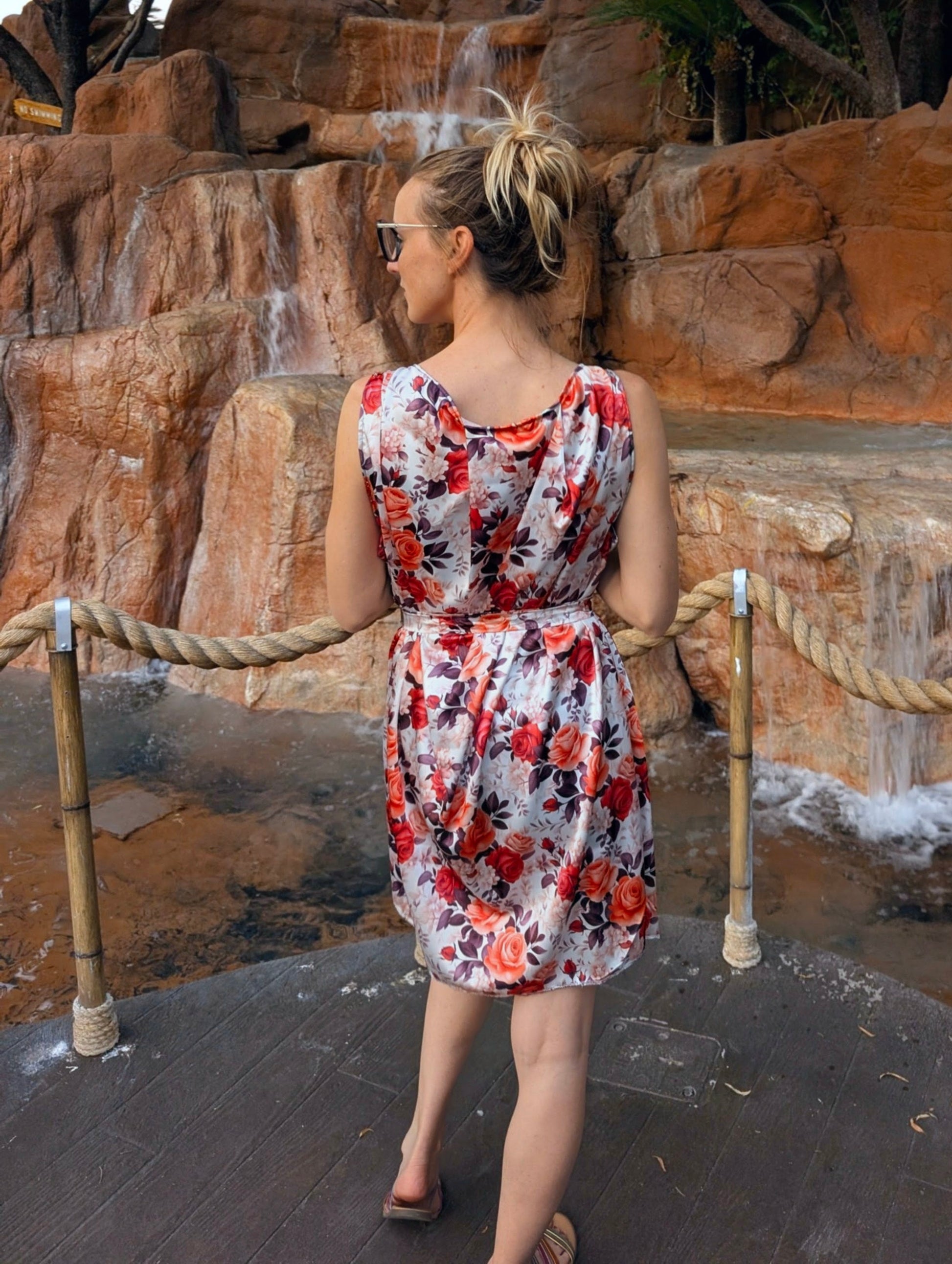 Red Satin red floral dress with size adjustable waist belt from the back view