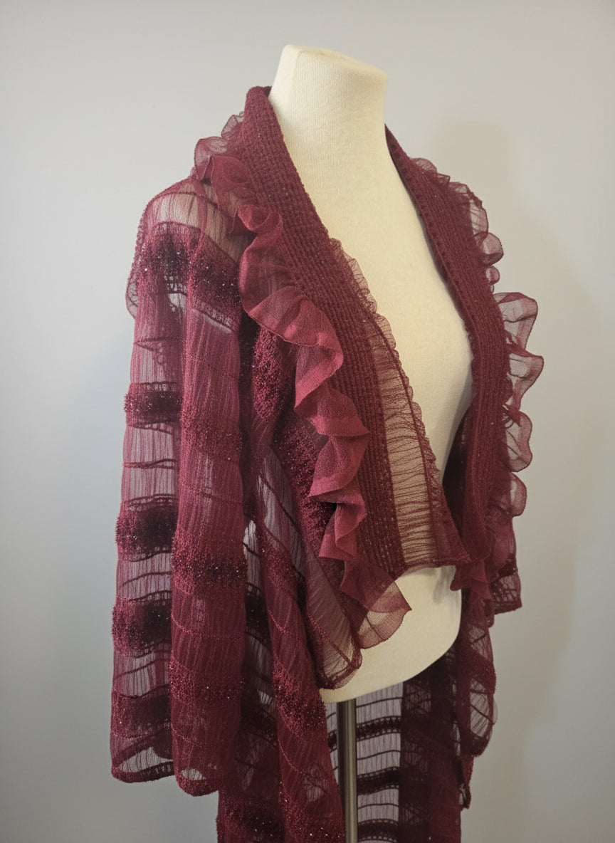 This photo shows a red, transparent overcoat that is size inclusive on a mannequin