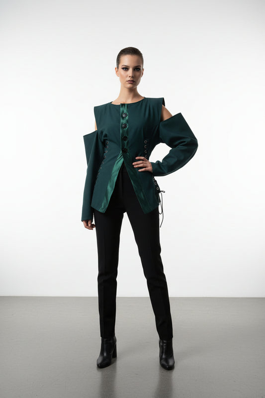 This photo shows a model wearing a dark green blazer with off the shoulder sleeves that are size adjustable at the waist
