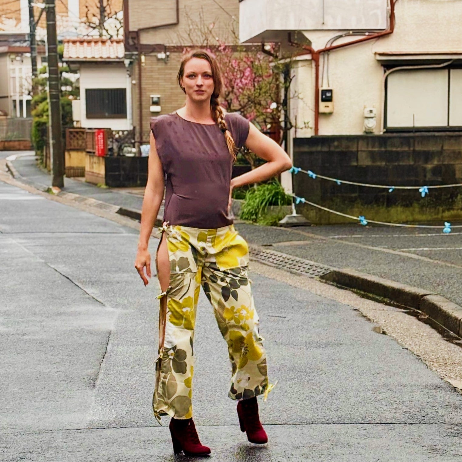 This photos shows a model wearing the size adjustable open thigh tie pants. 