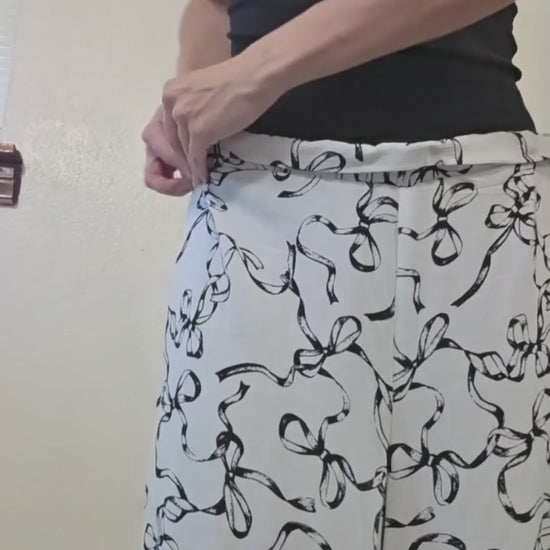 This video shows the adjustment process of the black and white bow set with adjustable pants