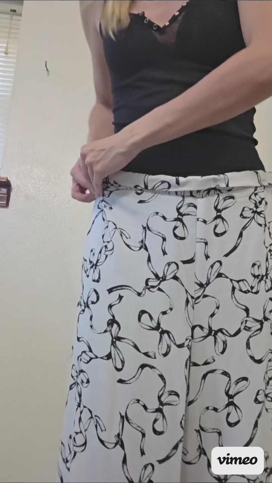This video shows the adjustment process of the black and white bow set with adjustable pants