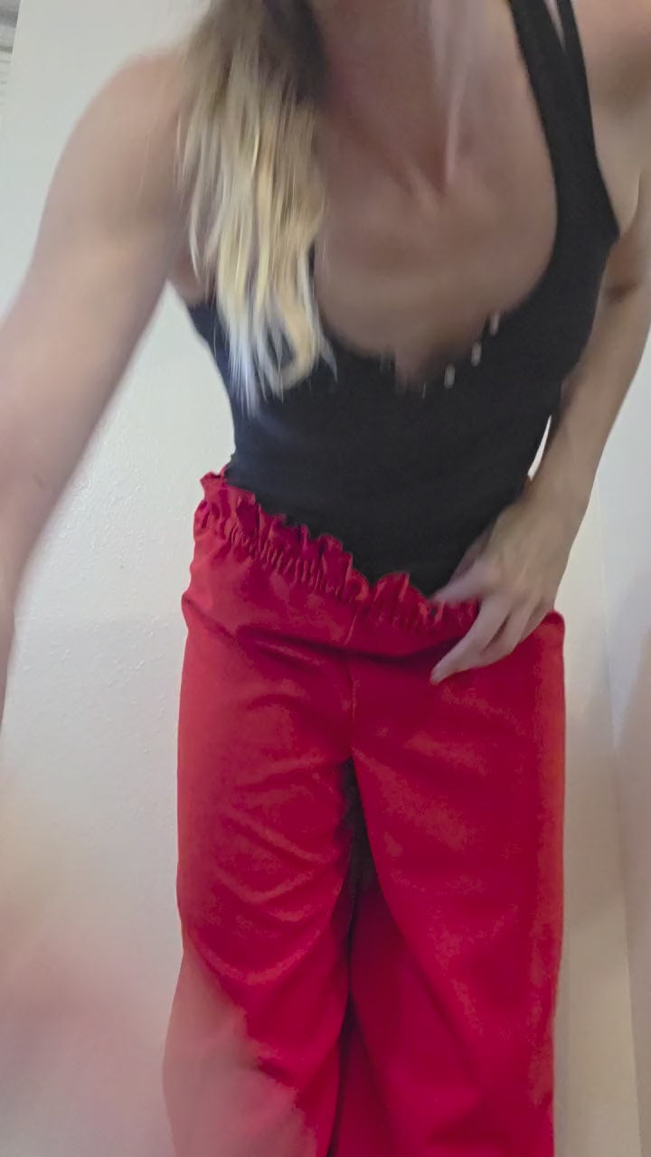 This photo shows a pair of red wide leg palazzo pants with a size- adjustable waistband. 
